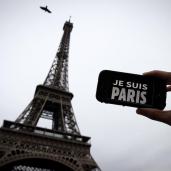 In this illustration picture taken in Paris on November 14, 2015 a person holds aloft a smartphone bearing the message "Je Suis Paris" in front of the Eiffel Tour, following a series of attacks on the city in which at least 128 people were killed. Islamic State jihadists on Saturday claimed a series of coordinated attacks by gunmen and suicide bombers in Paris that killed at least 128 people in scenes of carnage at a concert hall, restaurants and the national stadium. AFP PHOTO / JOEL SAGET (Photo credit should read JOEL SAGET/AFP/Getty Images)